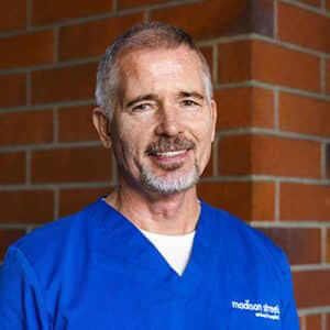 Madison Street Animal Hospital veterinarian portrait near a brick wall